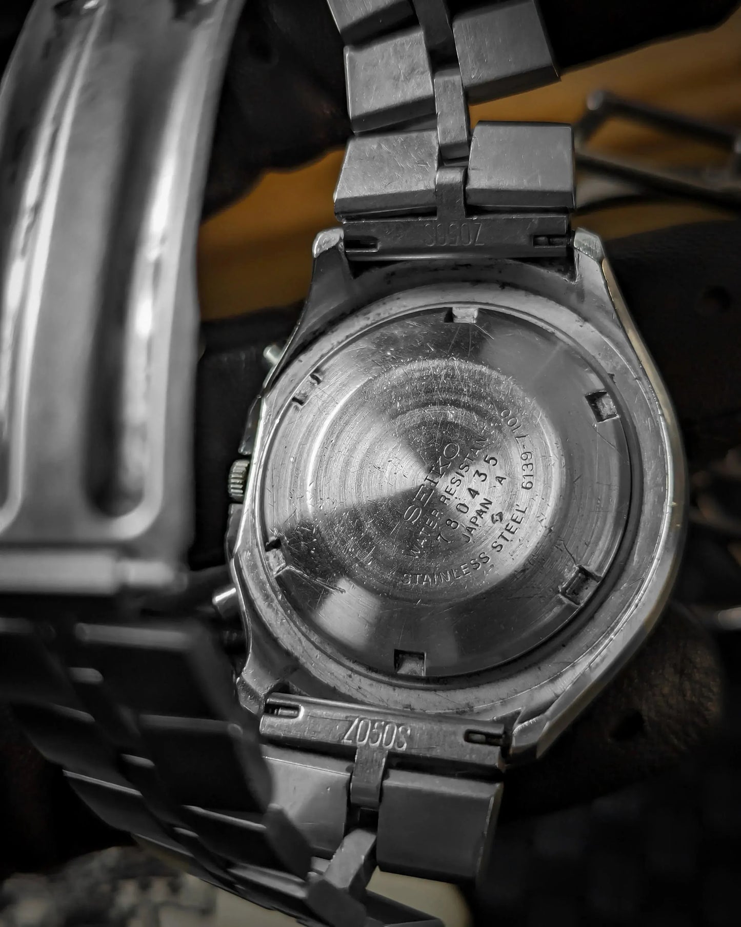 Close-up of vintage Seiko watch stainless steel case back and metal bracelet