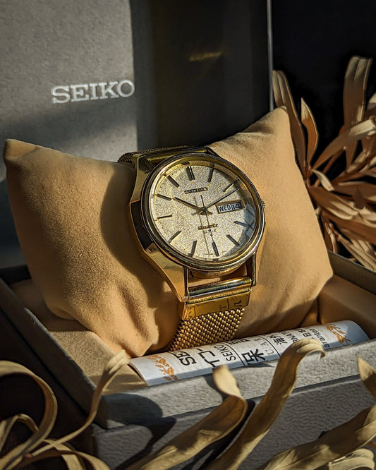 Gold Seiko quartz wristwatch with textured dial and mesh band in original gift box